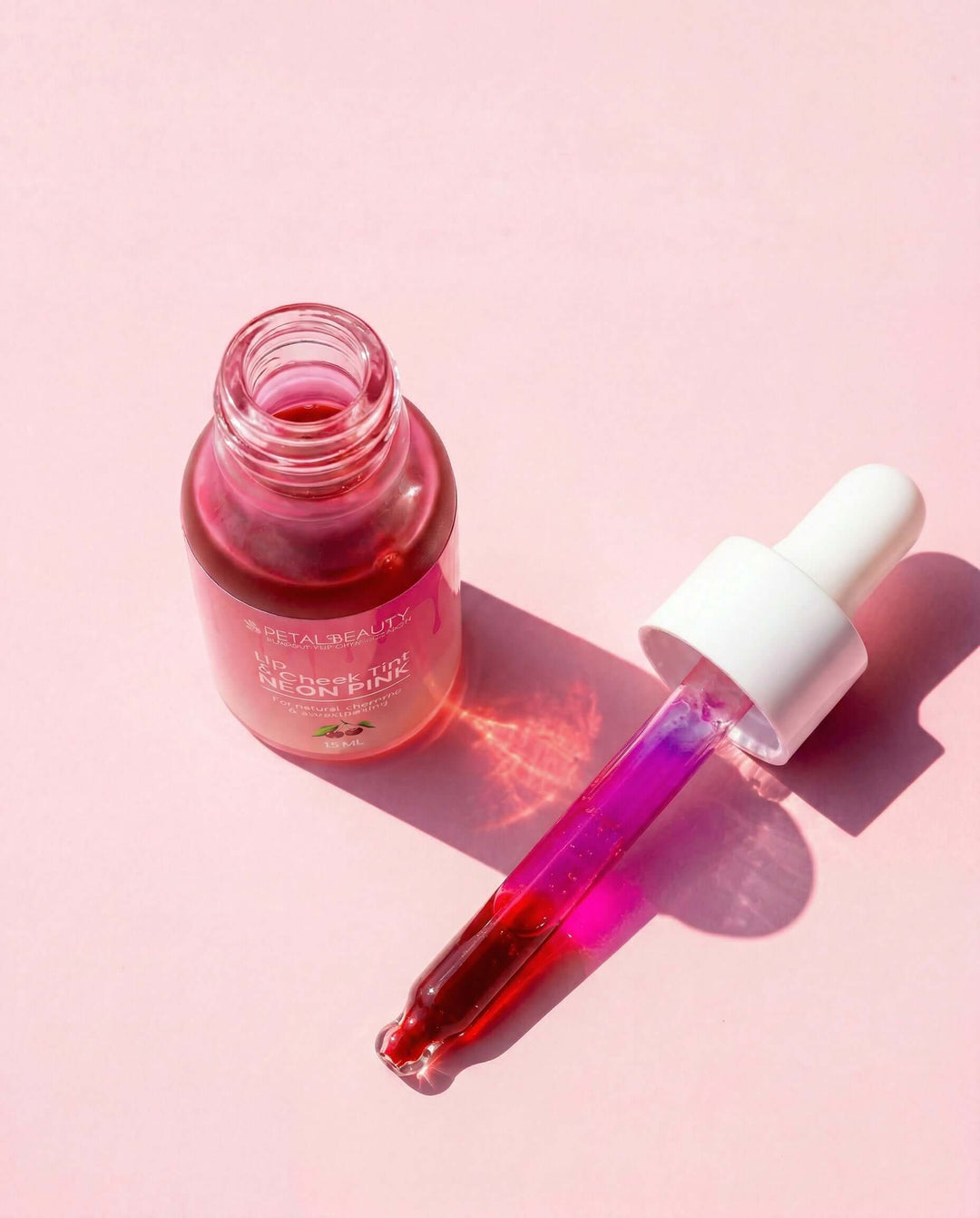 Neon Pink lip and cheek tint bottle with bright hot pink formula